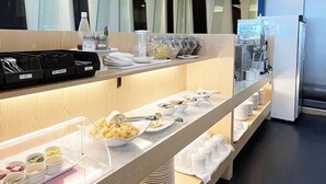 A buffet setup with various food containers and utensils. - Holiday Inn Express TAOYUAN by IHG (Taoyuan)