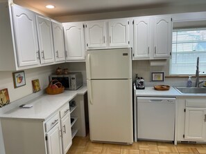 A compact kitchen with white cabinets, a refrigerator, a microwave, a toaster, and a sink. - 12 Min to Great Lakes Naval Station Navy Graduation Family Home (Waukegan)