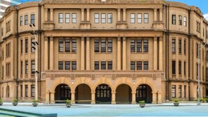 A historic building with a symmetrical facade, large windows, and a central entrance with three arches. - Ximen Relite Hotel (Taipei)