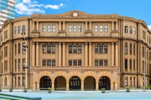 A large, historic building with a symmetrical facade, multiple windows, and a central entrance with arches. - Ximen Relite Hotel (Taipei)