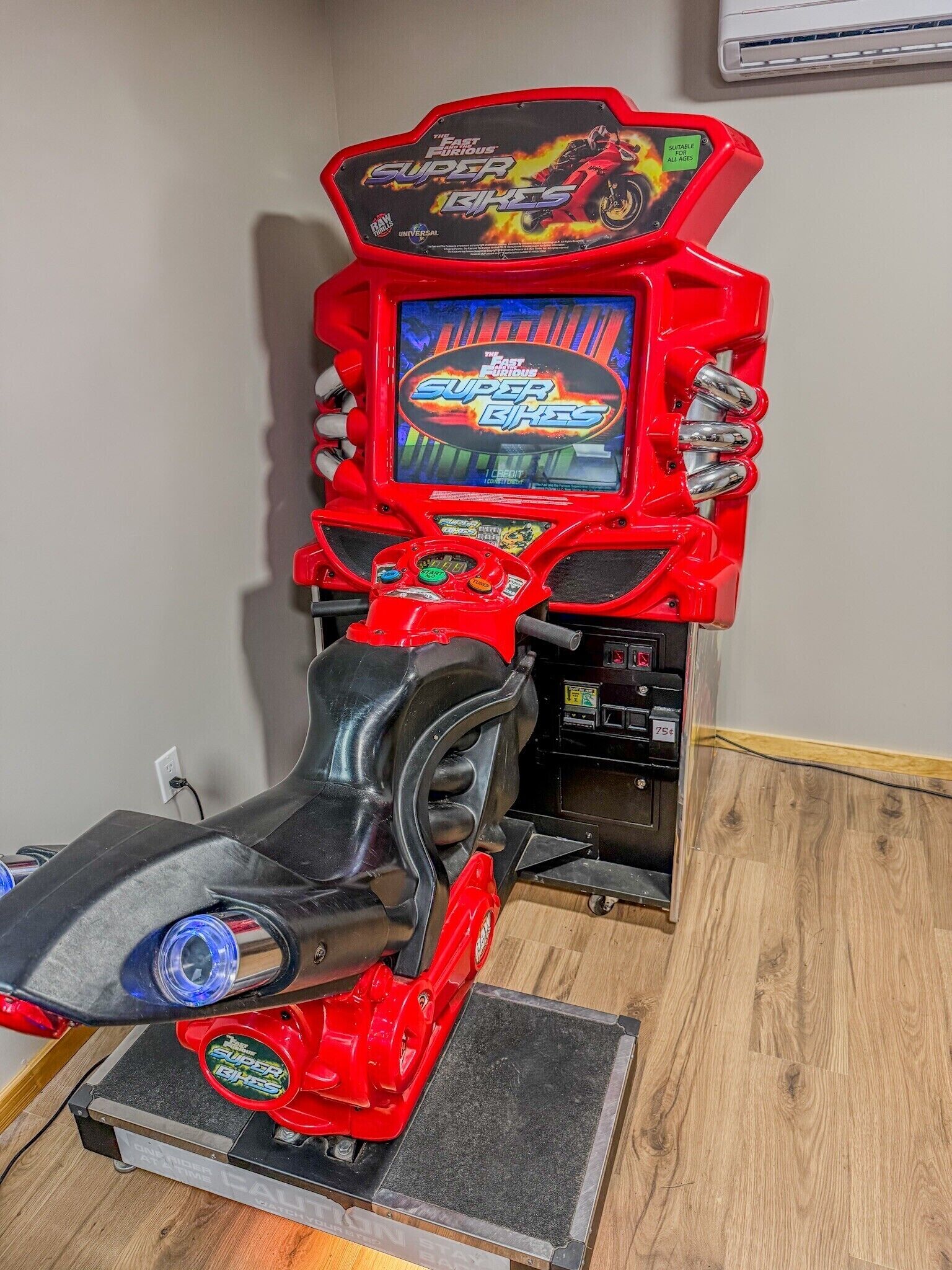 A red arcade racing game machine with a digital display and a steering wheel.