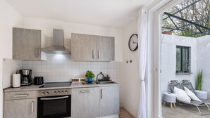 A modern kitchen with grey cabinets, a built-in oven, and a coffee maker. - AlbGlück 2, Hechingen, 1–7 people, castle 5 km away (Hechingen)