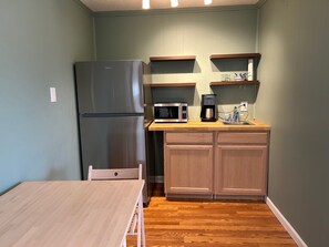Fridge, microwave, coffee/tea maker, cookware/dishes/utensils