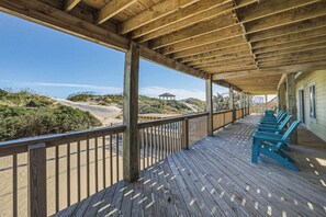 A wooden deck with a view of the beach and dunes. - Tide's a Wastin' | Oceanfront | Private Pool and Hot Tub (Nags Head)