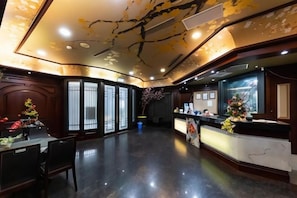 A hotel lobby with a reception desk, seating area, and a decorative ceiling. - I Hi Sanduo hotel (Kaohsiung)