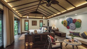 A spacious living room with a high ceiling, wooden beams, and a large window. - Avana Retreat (Bao La)