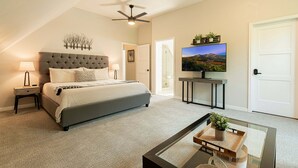 A bedroom with a bed, a ceiling fan, a TV, and a door. - Walk to Main Street & Town Lift, Private Hot Tub, Garage Parking, On Shuttle Route (Park City)