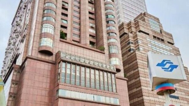 A high-rise building with a prominent logo on the side. - Twin Star Inn (Taipei)