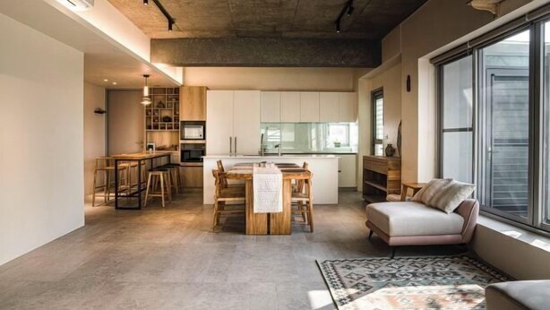 A modern kitchen with white cabinets, a dining area with a wooden table and chairs, and a large window providing natural light. - Living In Light　　　　　　 (Chiayi County)