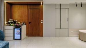 A modern kitchen with a built-in refrigerator, wooden cabinetry, and a countertop with various appliances. - 3 bedroom apartment (Giza Governorate)