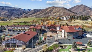 A hotel with a traditional European architectural style, featuring multiple buildings with red roofs and a central courtyard. - Beautiful updated Villa w/ Resort Amenities + Holistic Body Services Villa 3023-1 (Midway)