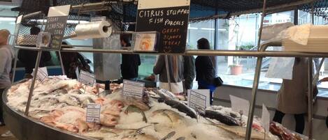 A seafood display with various fish and citrus stuffed fish parcels.