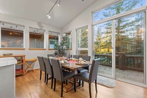 A dining area with a wooden table, chairs, and a plant. - Abode at Sawtooth, access to ranch clubhouse (Sun Valley)