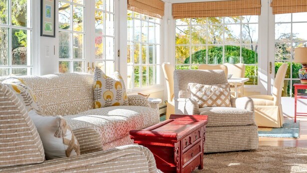 A sunlit room with a sofa, armchairs, and a red chest of drawers. - Farlea: Classic Country Charm Minutes from UVA (Charlottesville)