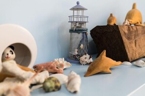 A small, enclosed space with a toy panda, a decorative lantern, and various seashells. - Hualien Yi Jing BnB (Hualien)