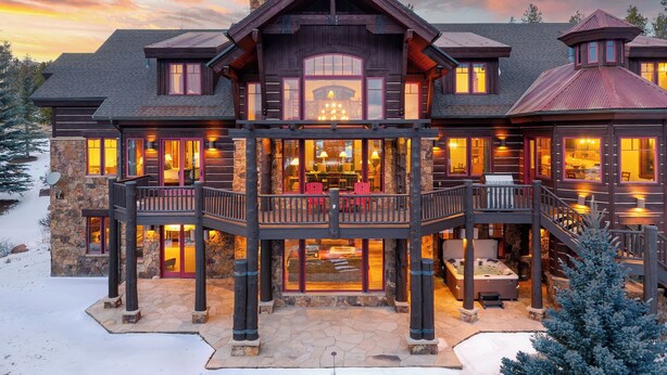 A large, multi-story wooden lodge with a balcony and hot tub, surrounded by snow. - Fore Seasons Lodge | Pole Creek Golf Course | Private Hot Tub | Sleeps 16! (Tabernash)
