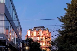 A multi-story building with a modern facade and a balcony on the upper floors. - The Pink Boutique Hotel (Dalat)