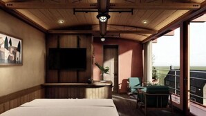 A room with a bed, a TV, a small bar area, and a balcony with a view. - The Pink Boutique Hotel (Dalat)