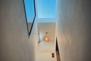 A narrow stairway with a skylight and a hanging light fixture. - Wuzheng Wood hall (Chiayi County)