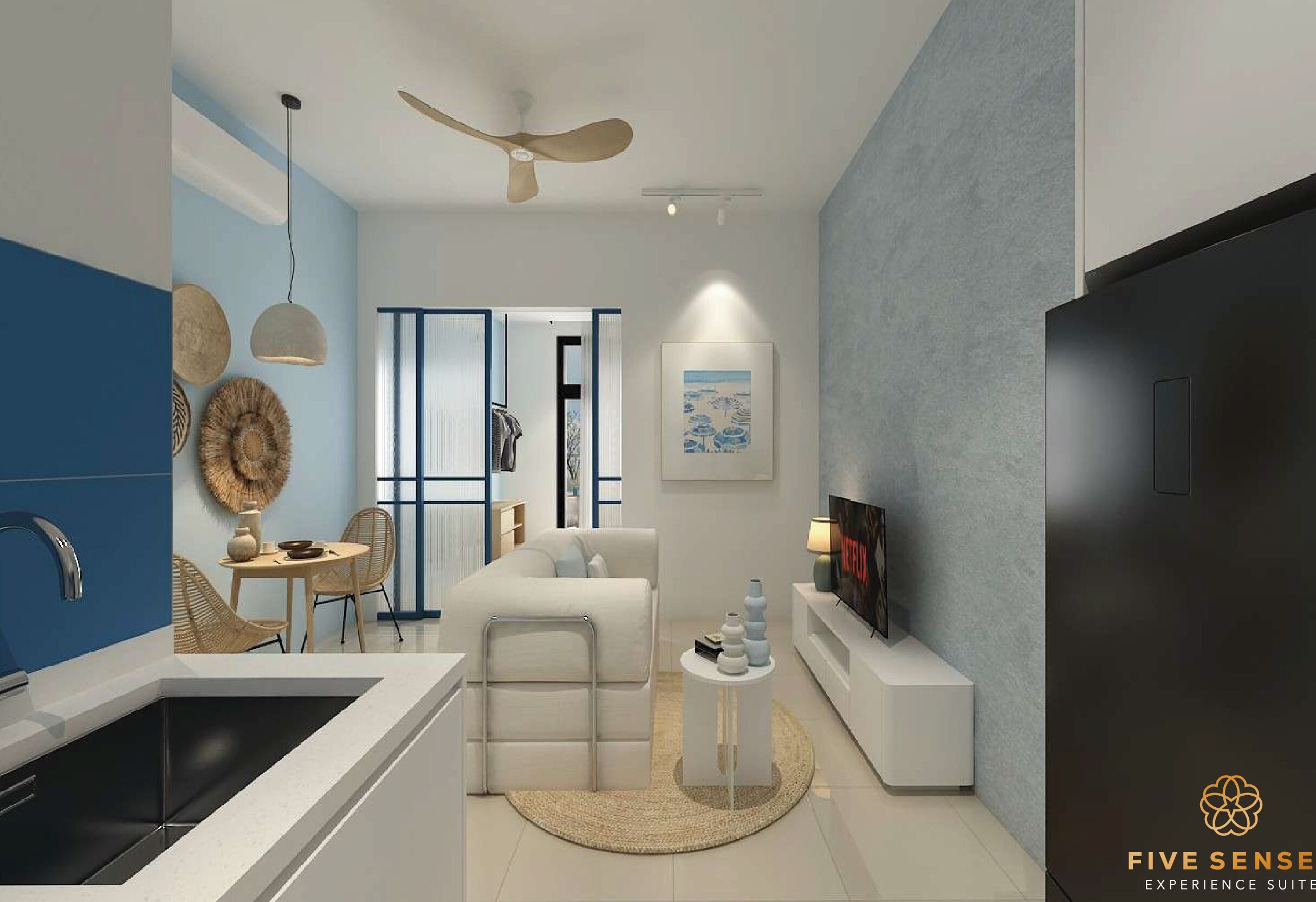 A modern living room with a sofa, TV, and decorative items. There is a kitchen area with a sink and cabinets.