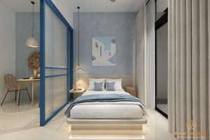 A modern bedroom with a bed, bedside table, lamp, chair, and a painting on the wall.