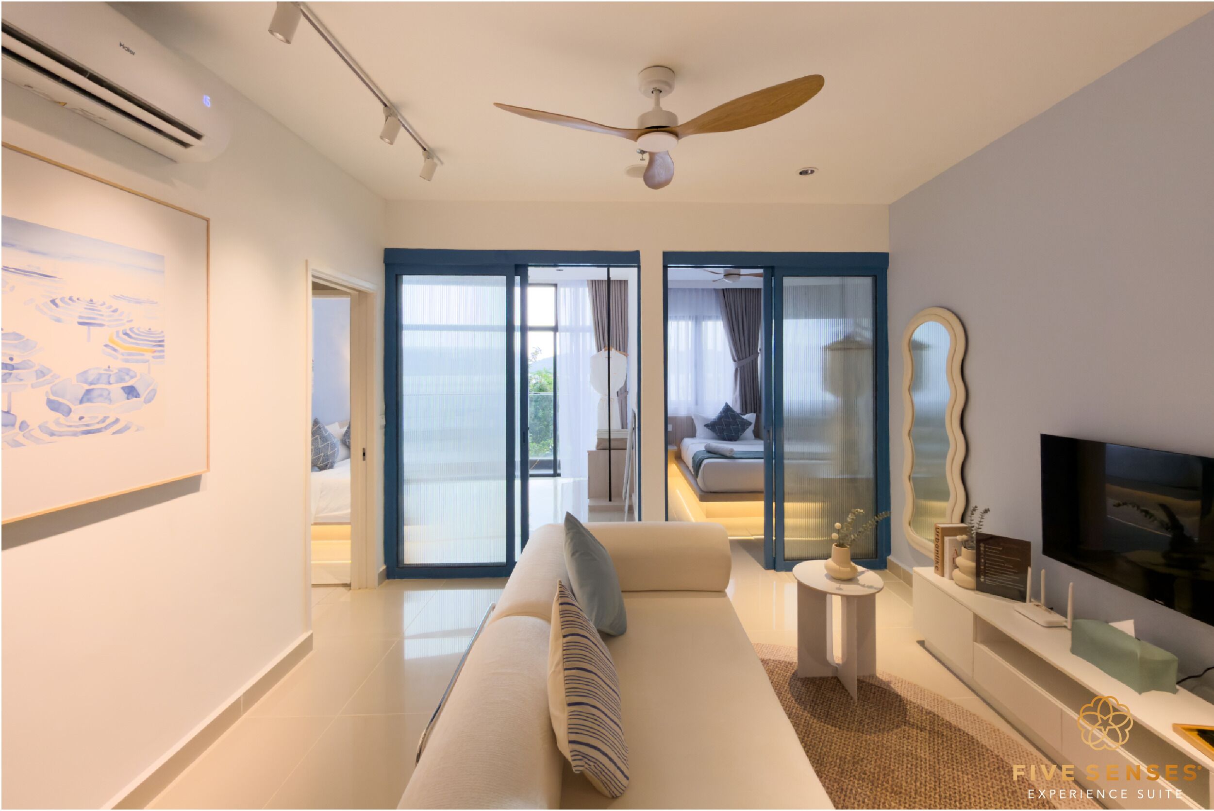 A modern hotel room with a large bed, a ceiling fan, a TV, and a view of the outdoors.