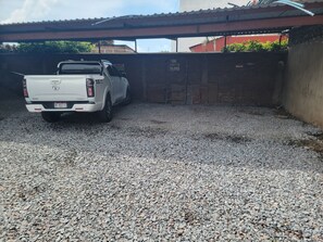 A white pickup truck parked in a gravel driveway.