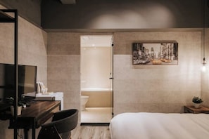 A modern hotel room with a bed, desk, chair, and a painting on the wall. - Pure meworld hotel (Taipei)