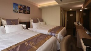 A hotel room with two beds, a desk, and a mirror. - Good Hotel (Kaohsiung)