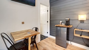 A modern kitchen with a built-in refrigerator, a wooden table, and a black chair. - Tahoe Mountain Inn #34 (SOUTH LAKE TAHOE)