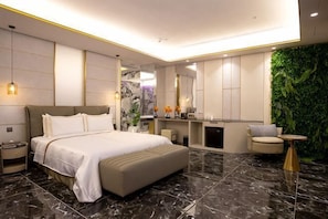A modern bedroom with a large bed, bedside tables, a vanity, and a green wall. - I Will Motel (Hsinchu County)