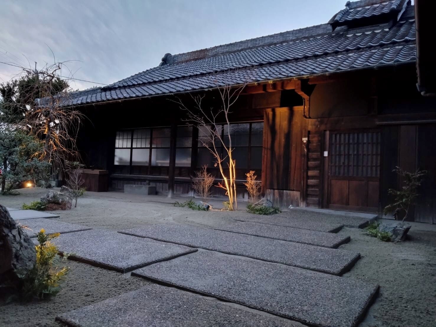 A traditional Japanese building with a tiled roof and wooden structure.