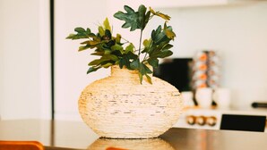A kitchen with a woven basket vase on the counter, two wooden chairs, and a microwave in the background. - *Free Parking* Cozy 2br/2ba Penthouse DT Halifax! (Halifax)