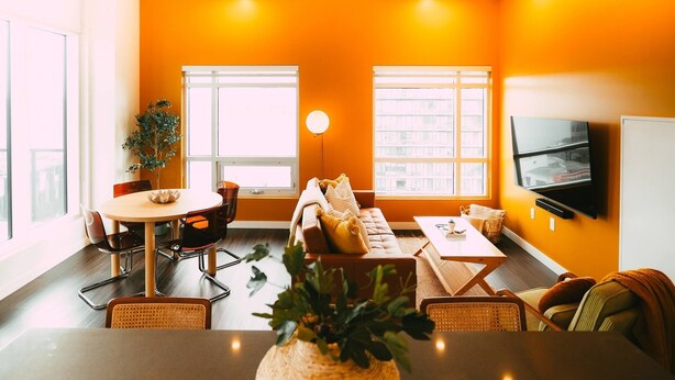 A modern living room with a sofa, dining table, chairs, a plant, and a TV. - *Free Parking* Cozy 2br/2ba Penthouse DT Halifax! (Halifax)