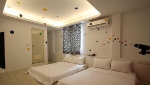 A hotel room with two beds, a ceiling light fixture, a window with a decorative screen, and an air conditioning unit. - Mr.Rabbit (Pingtung)