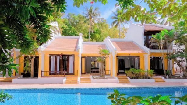 A two-story building with a swimming pool in front. - Hoi An Phu Quoc Resort & Spa (Phu Quoc Island)