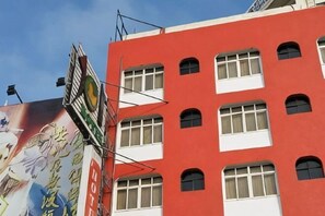 A red building with multiple windows and a sign that reads 'HOTEL.' - 101 Hotel (Hsinchu)