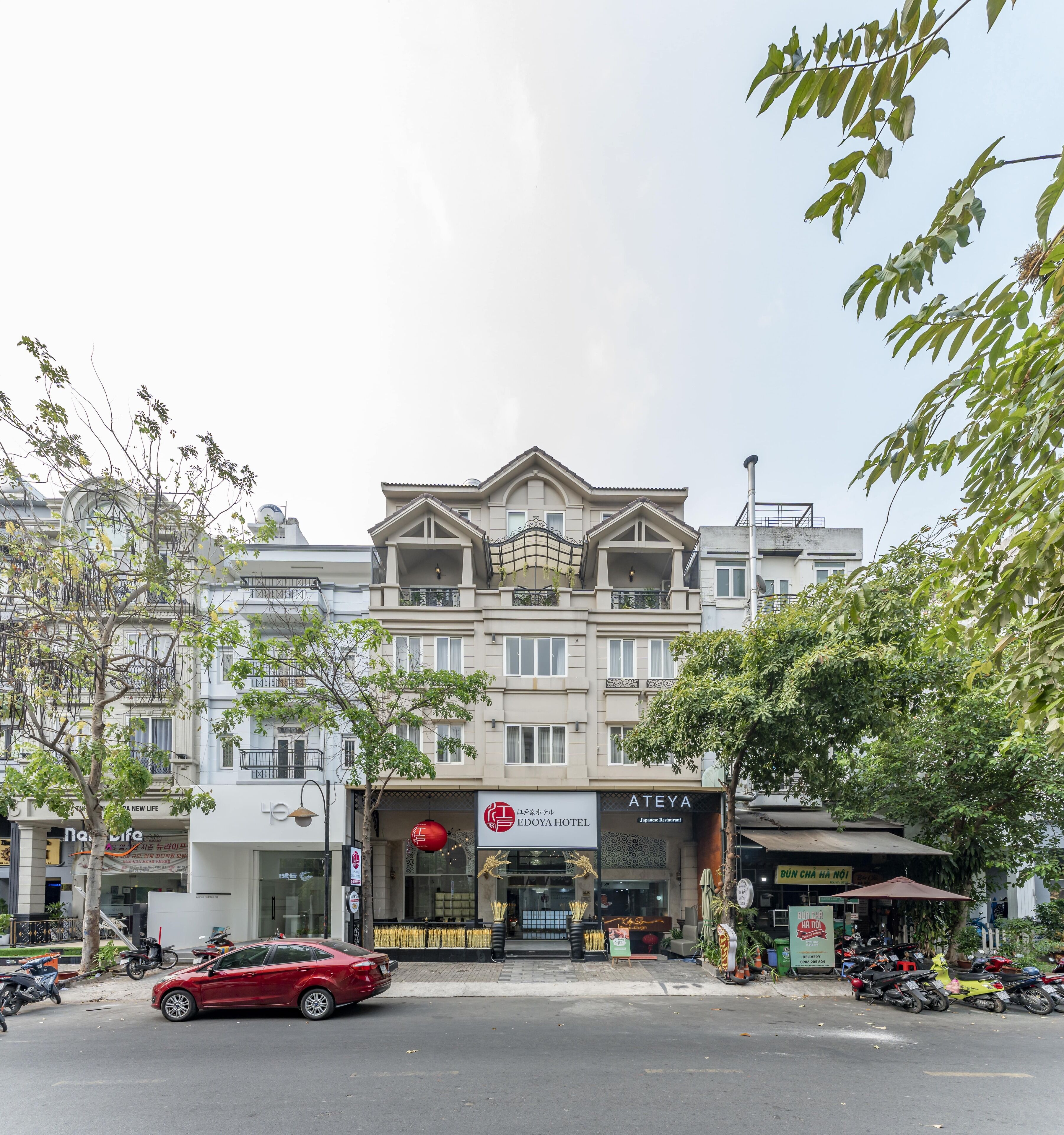 A hotel with a traditional architectural style, featuring a prominent entrance and a sign indicating it is a Japanese restaurant.