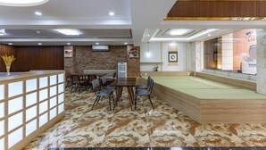 A modern hotel lobby with a reception desk, seating area, and a pool table. - Edoya Hotel Phu My Hung (Ho Chi Minh City)