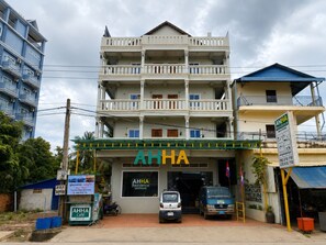 A multi-story building with a sign for AHHA Residence. - AHHA Residence Kampot (Kampot)