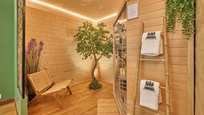 A wooden interior with a bench, a tree, and a towel rack. - Scandinavian Suite with private Spa & Sauna - High-end escape (Nantua)