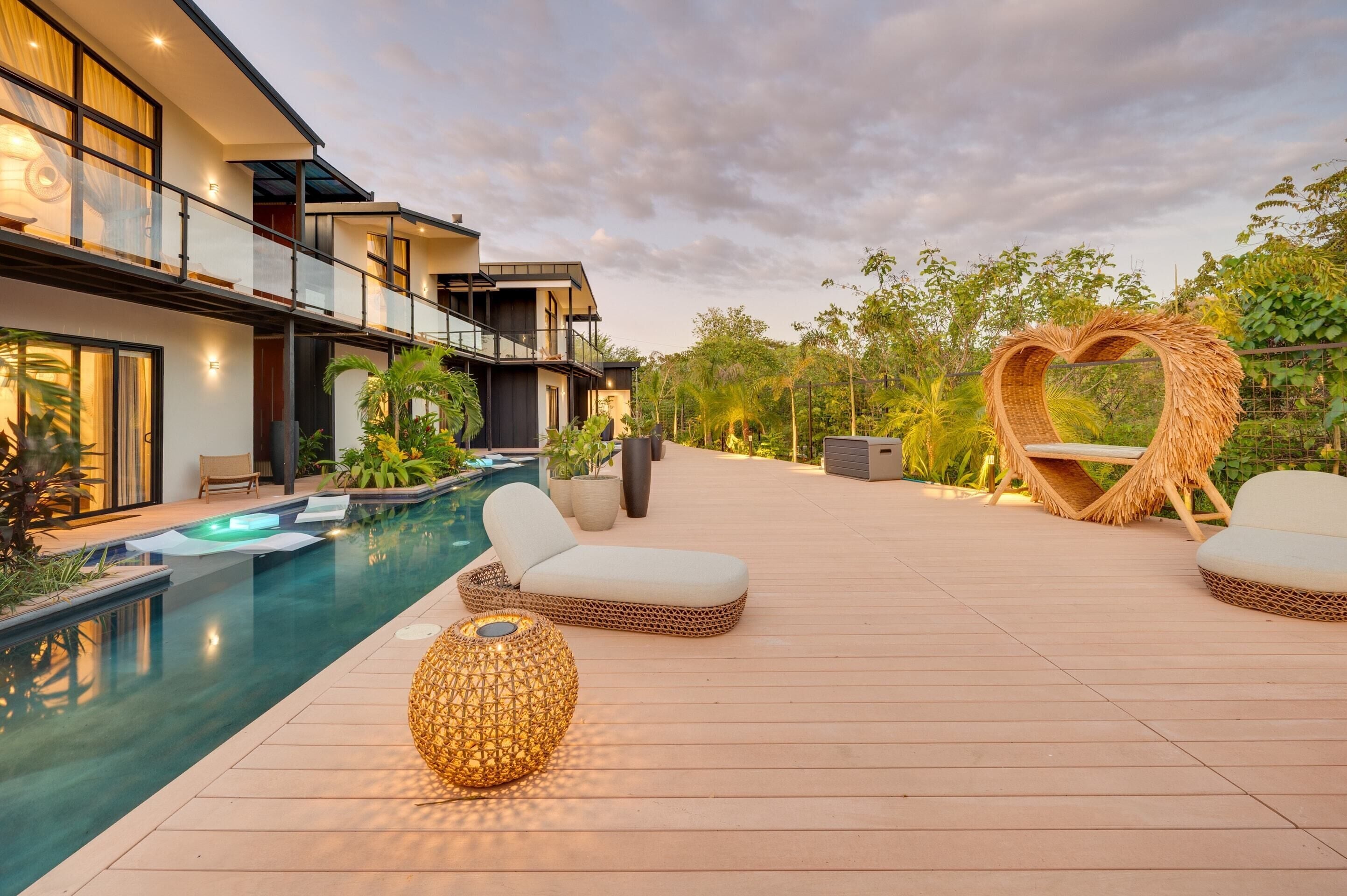 Una casa moderna con piscina, area relax esterna e decorazione a forma di cuore.