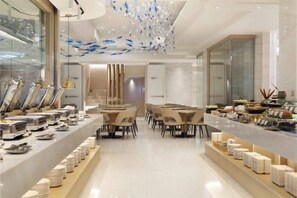A modern dining area with a long counter, multiple tables, and a decorative ceiling. - Gamalan Star Hotel (Yilan)
