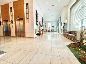 A spacious lobby with a polished tile floor, a reception desk, and a seating area with patterned upholstery. - Comfortable pad w/ best view, vicinity of Shangrila Mall and Hotel, ADB, SM Mall (Mandaluyong City)