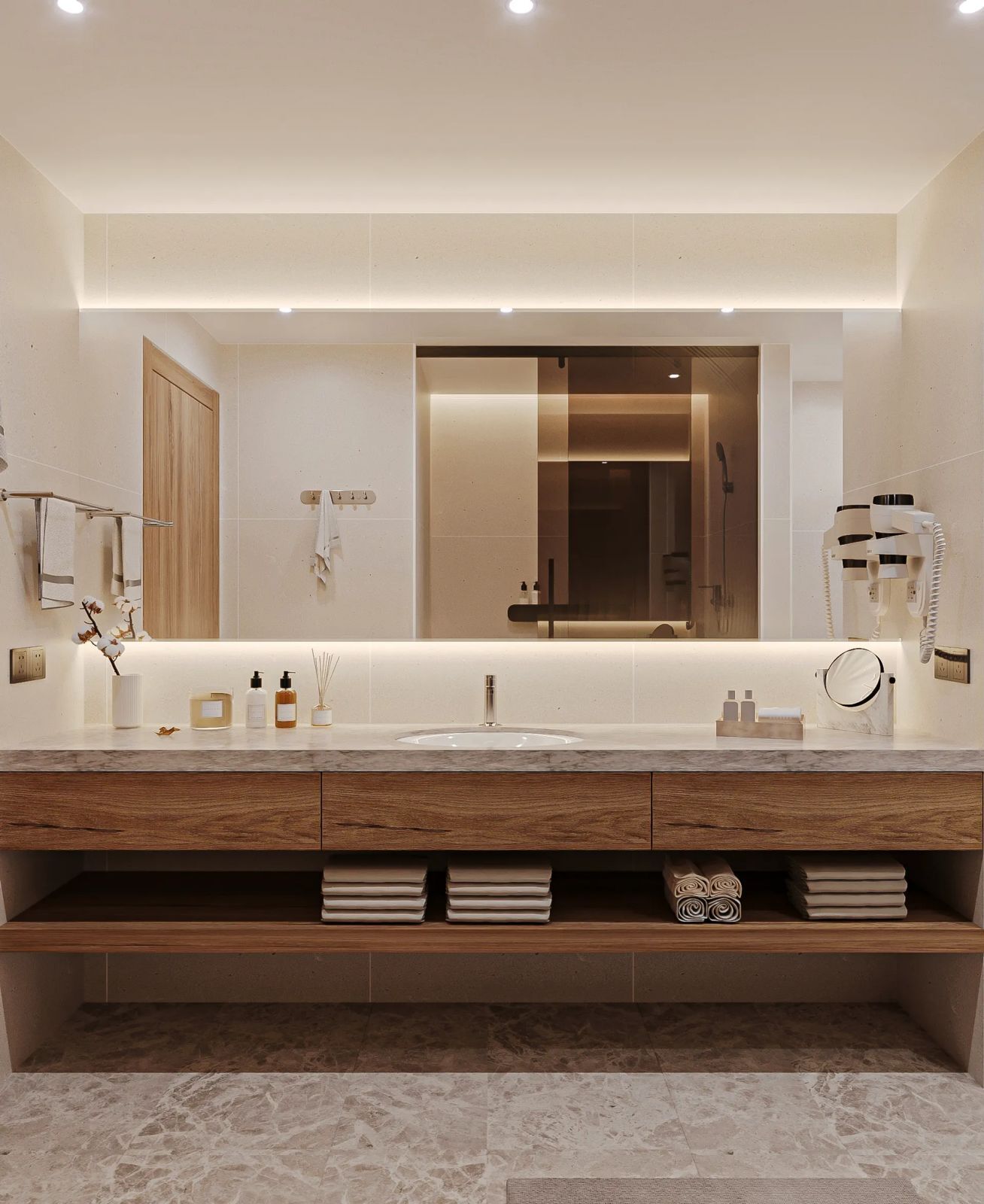 A modern bathroom with a large mirror, wooden vanity, marble countertop, and built-in shelves.