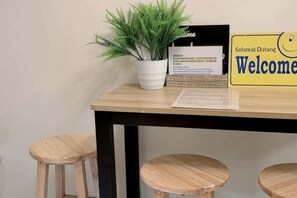 A reception desk with a laptop, a welcome sign, and a potted plant. - youcity @ Taipei 101 101mrt (The whole floor apartment is for you to use, large space,) (Taipei)