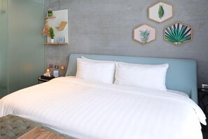 A bed with white linens, a nightstand with a lamp, and a wall with framed botanical prints. - youcity @ Taipei 101 101mrt (The whole floor apartment is for you to use, large space,) (Taipei)