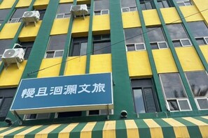 A building with multiple air conditioning units and a sign with Chinese characters. - Bantshiann Hualie Hotel (Hualien)
