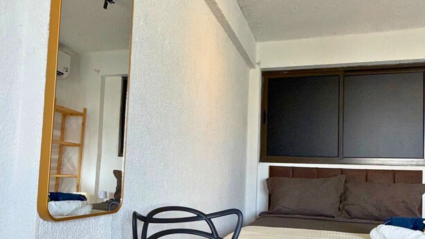 A room with a bed, a chair, a large mirror, and a wardrobe. - MHV Milagres - Guadalupe 11 (Passo de Camaragibe)