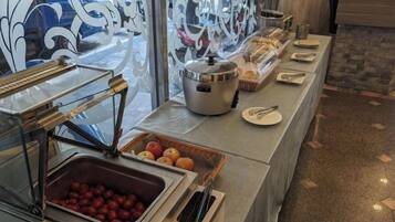 A buffet setup with various food items and serving utensils.